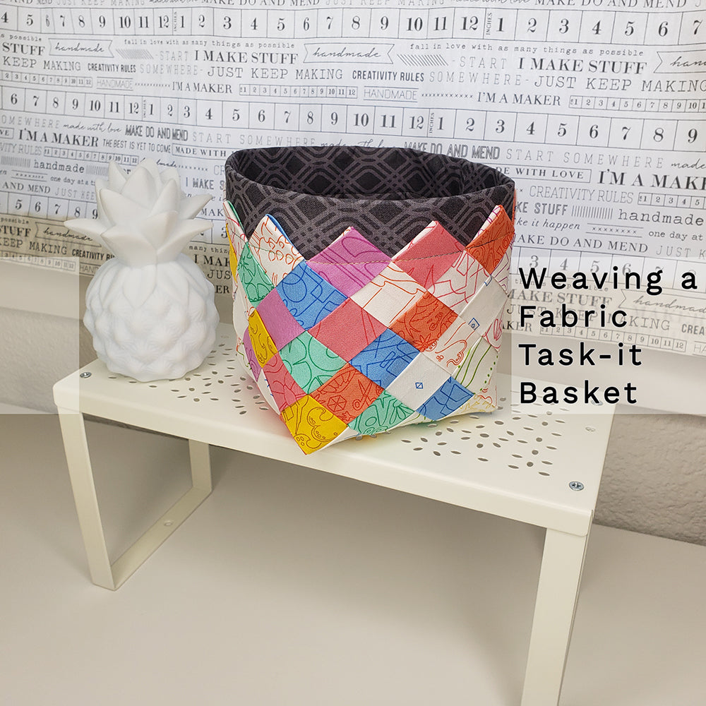 a small multi color woven basket on a stand with a white pineapple decoration